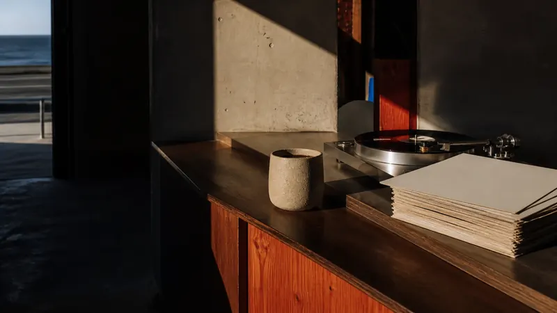 A coffee beside a record player by the sea